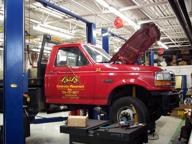 Fleet truck being serviced on a lift at Oval Auto
